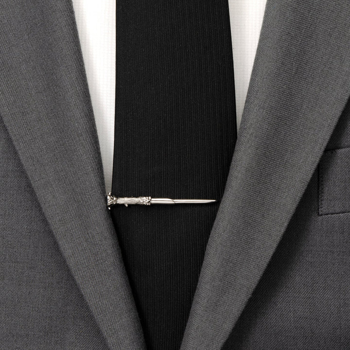 Silver-toned Harry Potter Wand Tie Clip worn on a black necktie and gray suit jacket.