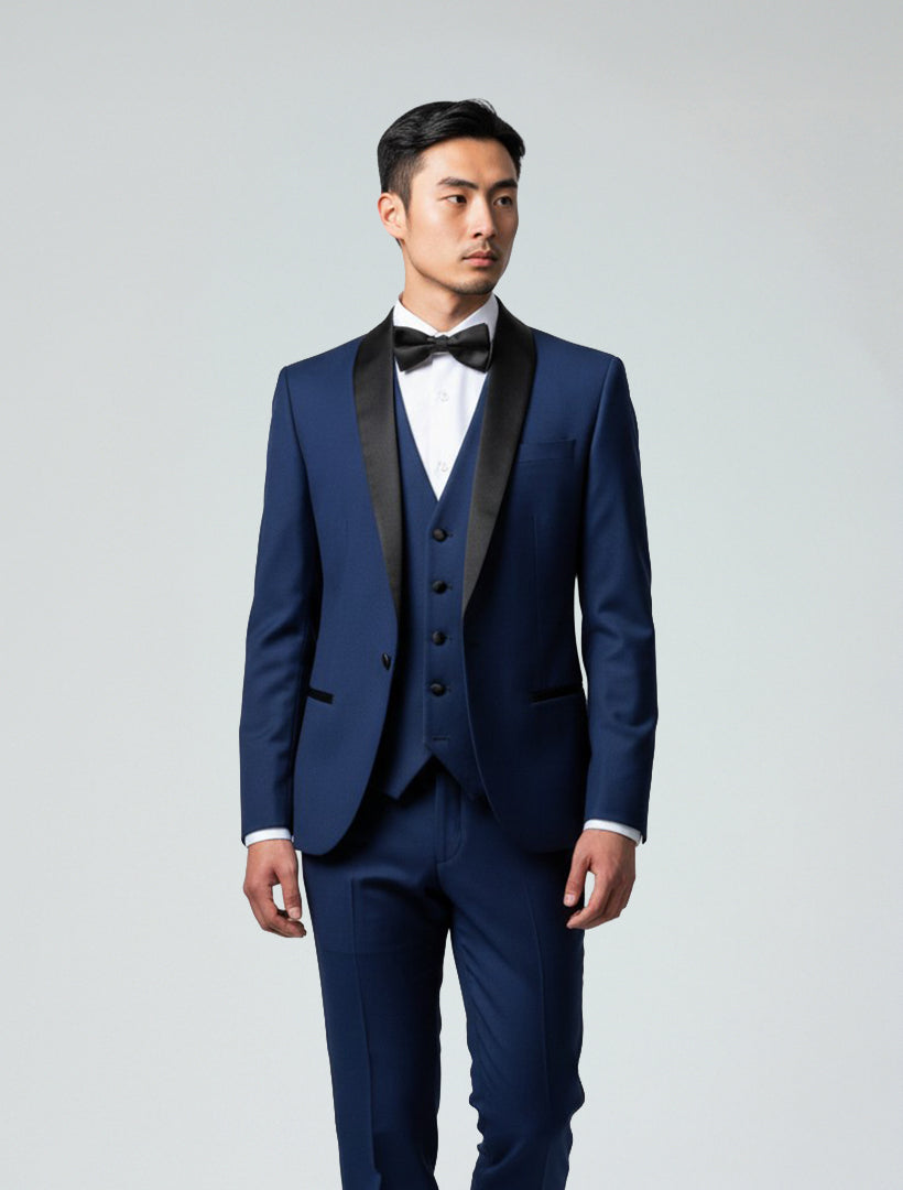 Model wears the Gino Vitale Men's Indigo Shawl Lapel Tailored Fit Tuxedo with a white dress shirt and black bow tie, set against a plain light gray background.