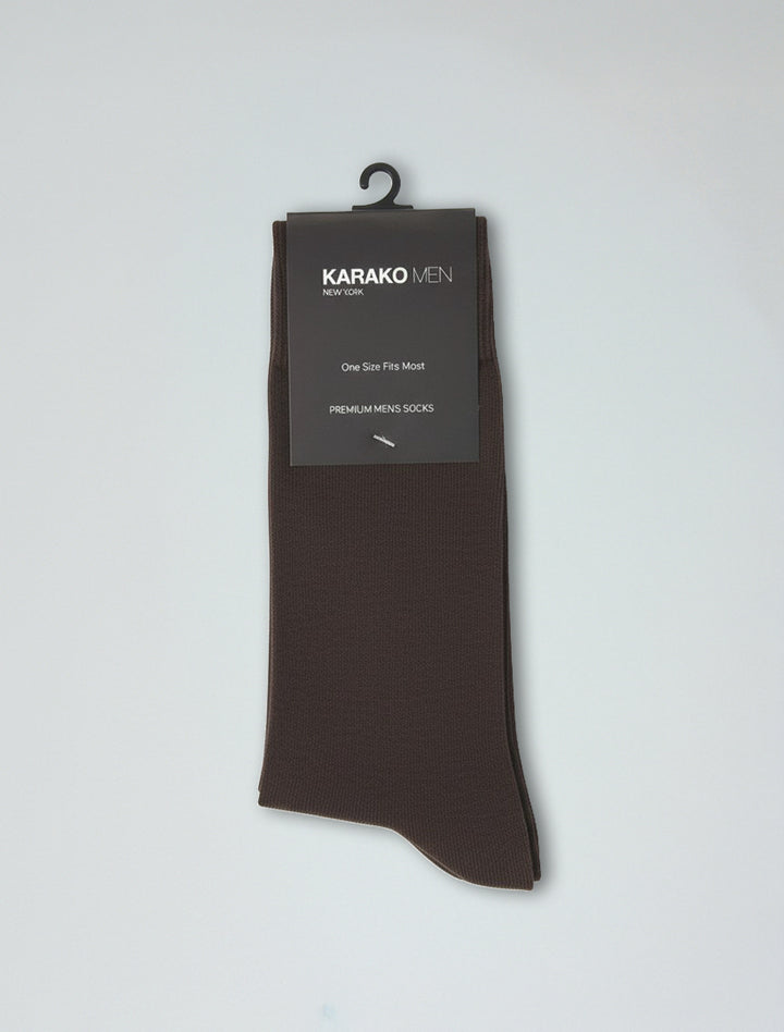 A pair of Karako Men Dark Brown Basic Dress Socks on a hanger with a black “KARAKO MEN, One Size Fits Most, Premium Men&