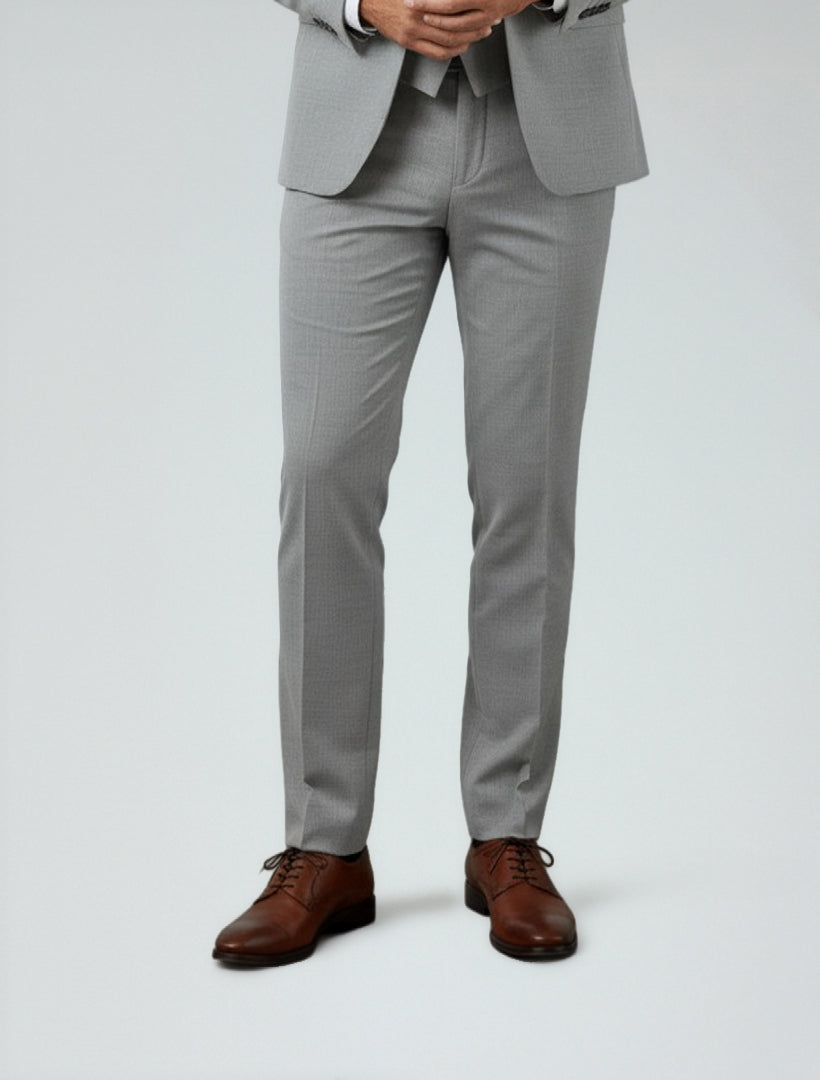 A person is shown from the shoulders down wearing Karako Separate's Light Grey Men's Slim-Fit Suit Separates Pants with brown dress shoes against a plain background.
