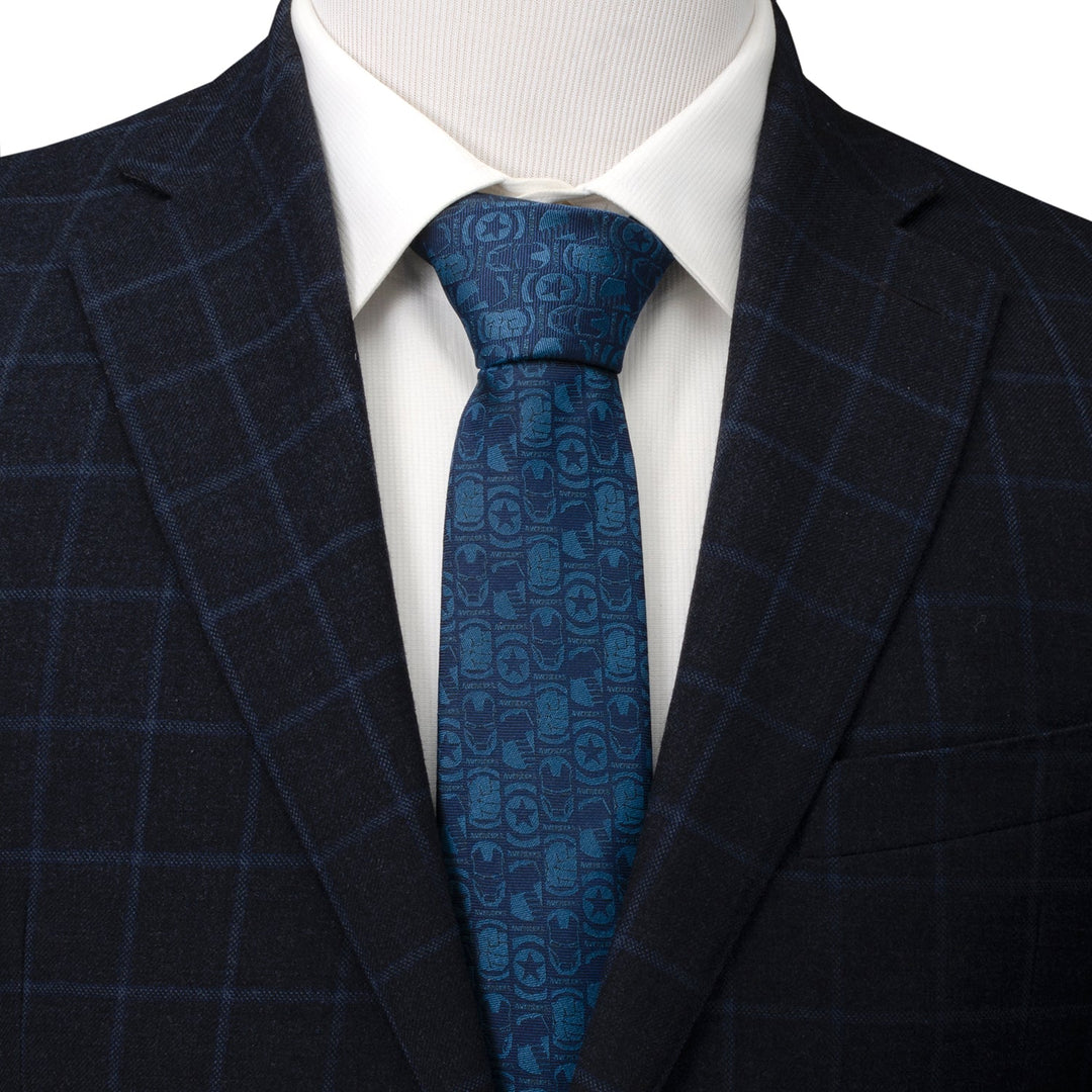 Marvel Avengers Men’s Blue Tie patterned with small repeating character masks and logos, worn with a white dress shirt and dark plaid blazer.