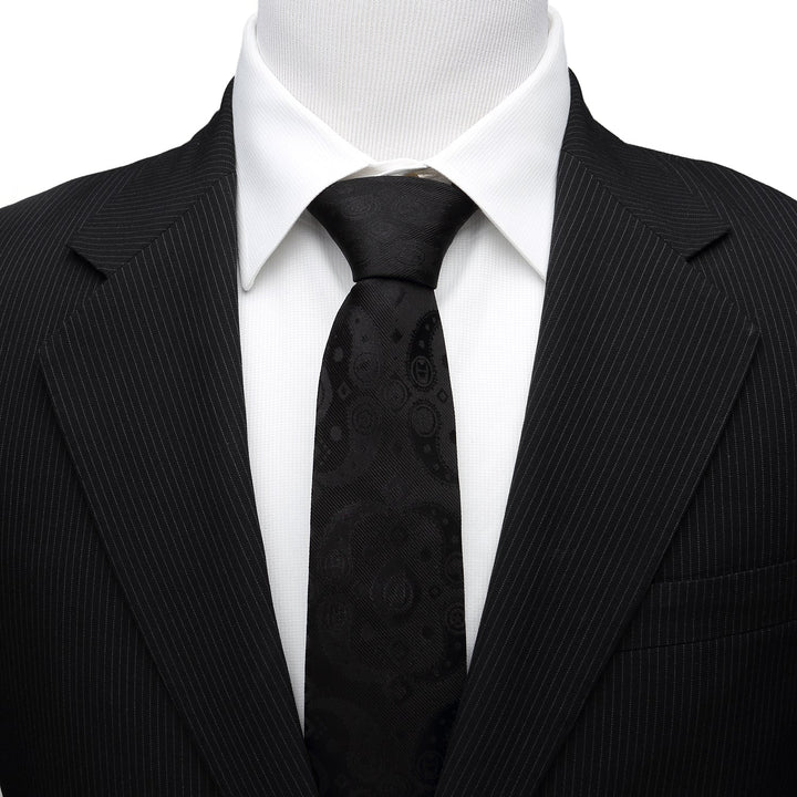 A Marvel Avengers Paisley Icons Print Black Tie worn with a white collared shirt and black pinstripe suit jacket.