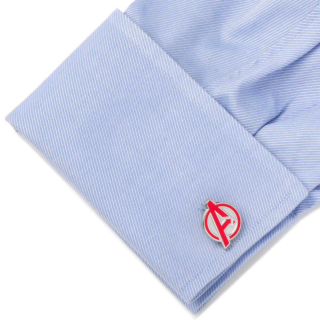 A light blue striped shirt cuff fastened with Marvel Avengers Cufflinks featuring a silver and red circular emblem with a stylized letter A.