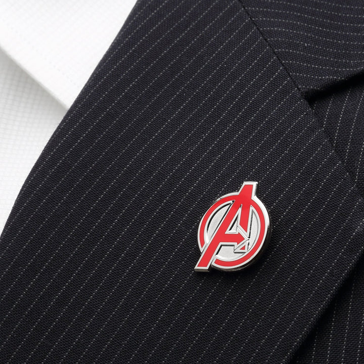 A red and silver Avengers lapel pin from the Marvel Avengers Favorites 3 Pair Socks and Lapel Pin Gift Set attached to a pinstriped suit jacket.