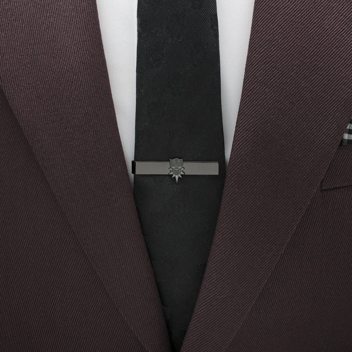 Marvel Black Panther Tie Bar in black metal featuring a mask icon, worn on a black tie and a dark suit jacket.
