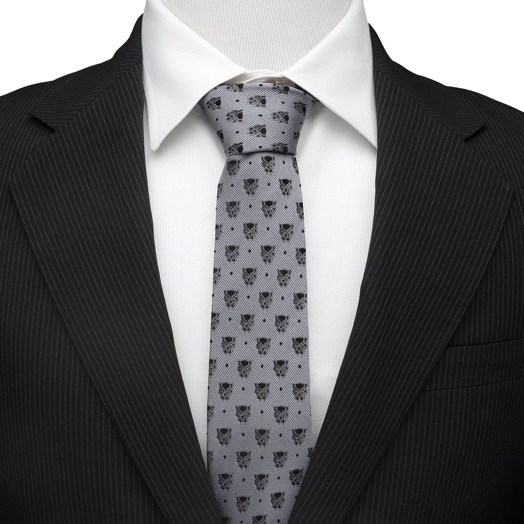 Marvel Black Panther Gray Dot Tie in gray silk with a repeating mask pattern, worn with a white shirt and black pinstripe suit jacket.
