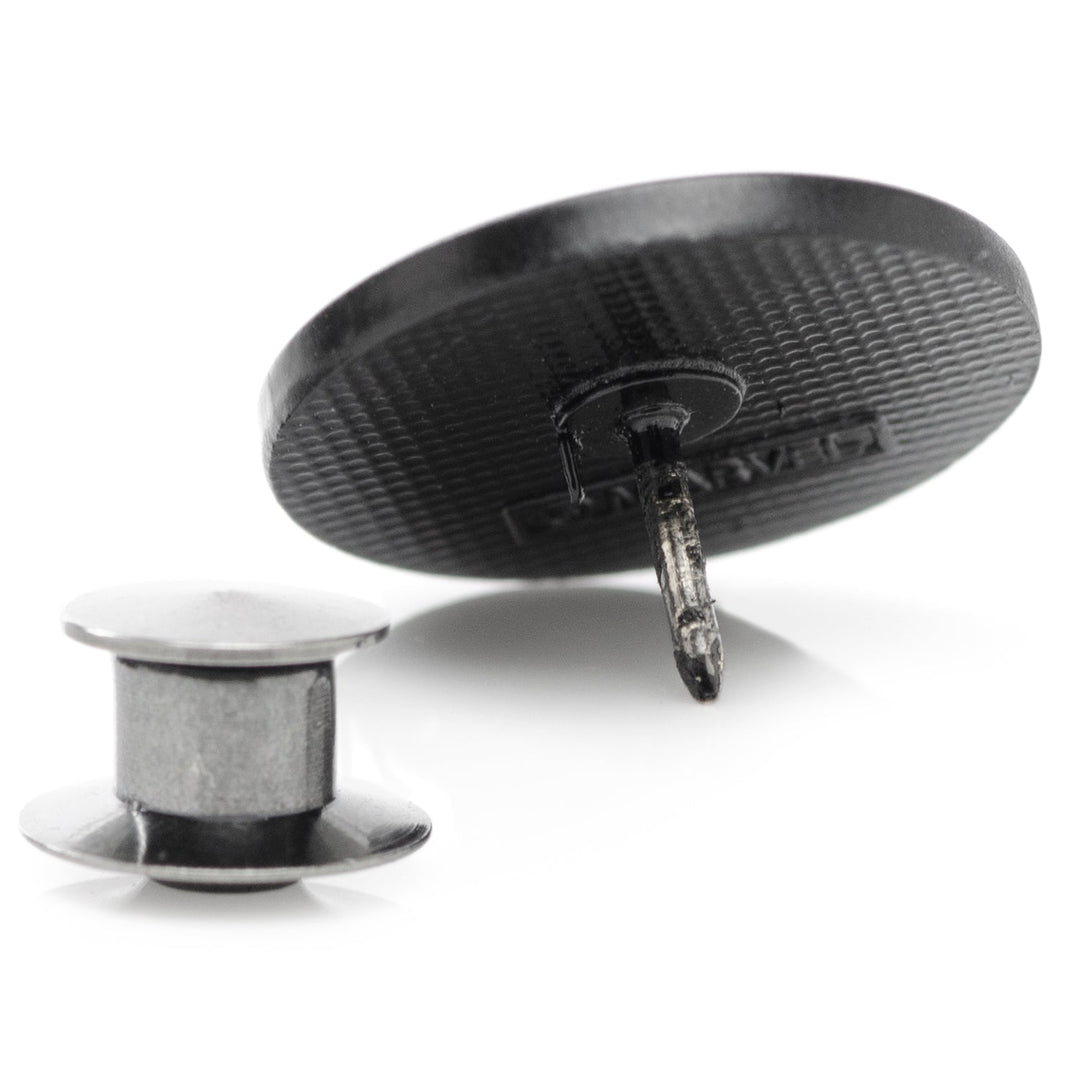 Back view of a round Marvel Black Widow Lapel Pin with a detached metal pin backing.