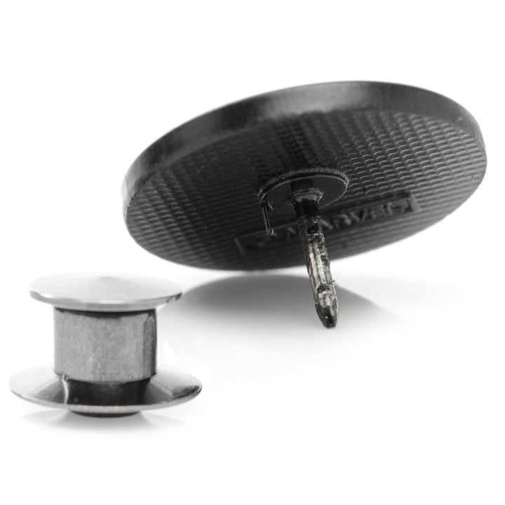 Back view of a round Marvel Black Widow Lapel Pin with a detached metal pin backing.