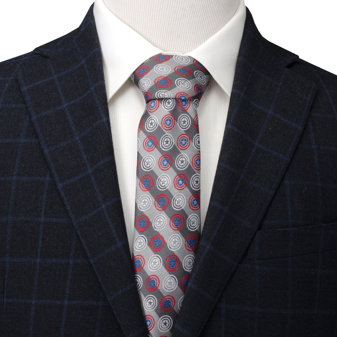 Marvel Captain America Gray Stripe Men’s Tie worn with a white collared shirt and a dark windowpane blazer, featuring a diagonal stripe pattern with repeated shield icons.