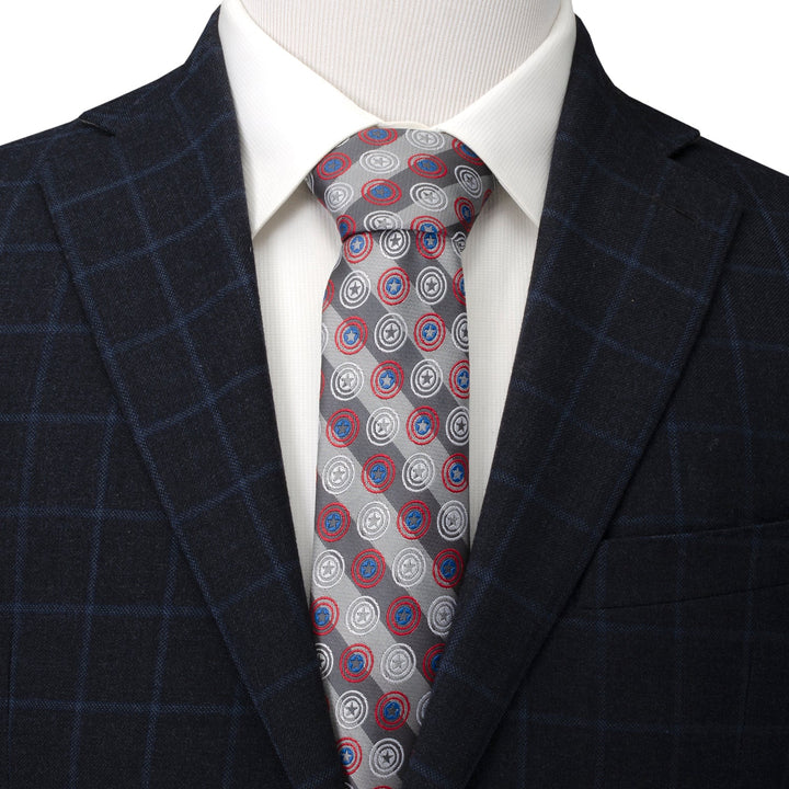 Marvel Captain America Gray Stripe Men’s Tie worn with a white collared shirt and a dark windowpane blazer, featuring a diagonal stripe pattern with repeated shield icons.