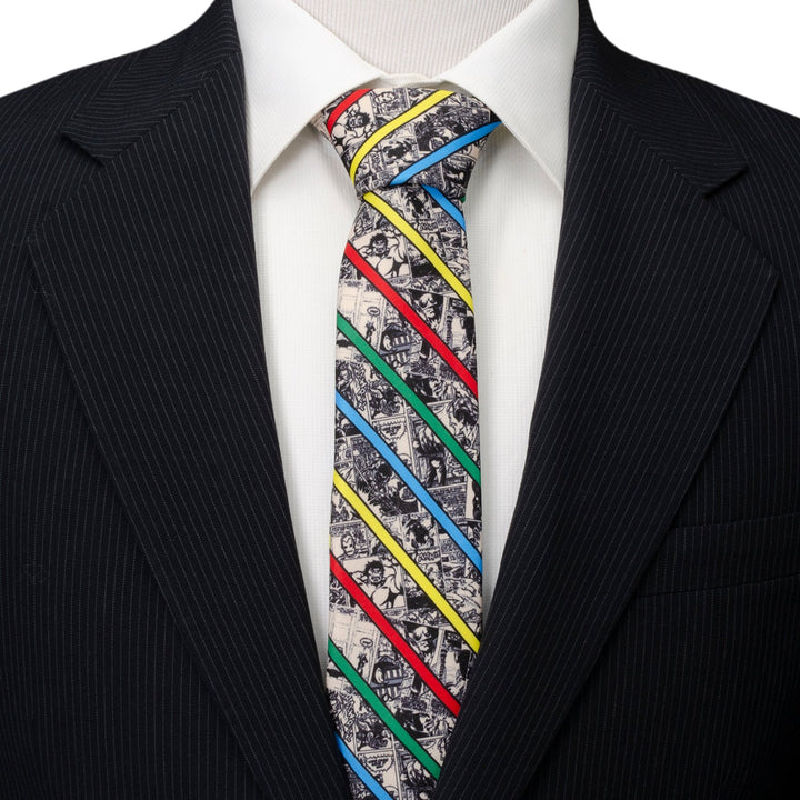 Marvel Comic Stripe Tan Men’s Tie in a black-and-white comic strip pattern with diagonal red, yellow, blue, and green stripes, worn with a white shirt and black pinstripe suit jacket.