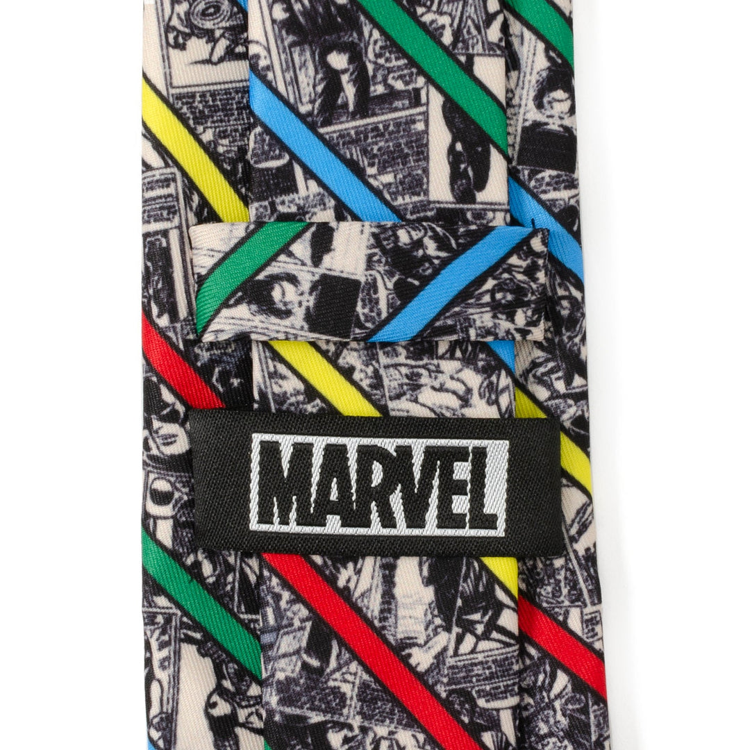 Close-up of a Marvel Comic Stripe Tan Men’s Tie featuring a black-and-white comic book print, diagonal red, blue, green, and yellow stripes, and a black tag that reads “MARVEL” in white text.
