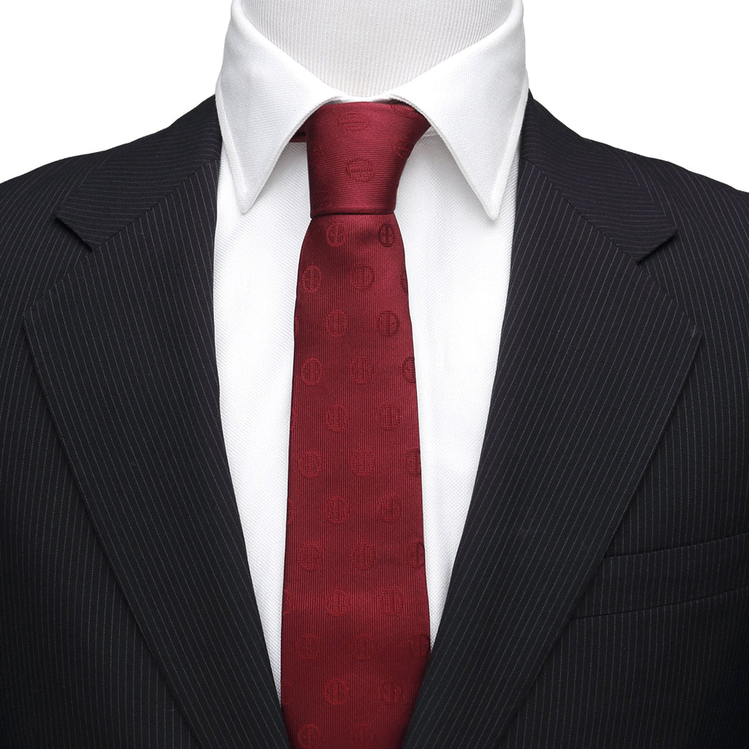 Marvel Deadpool Maroon Men’s Tie in a maroon repeating logo pattern, worn with a white shirt and black pinstripe suit jacket.
