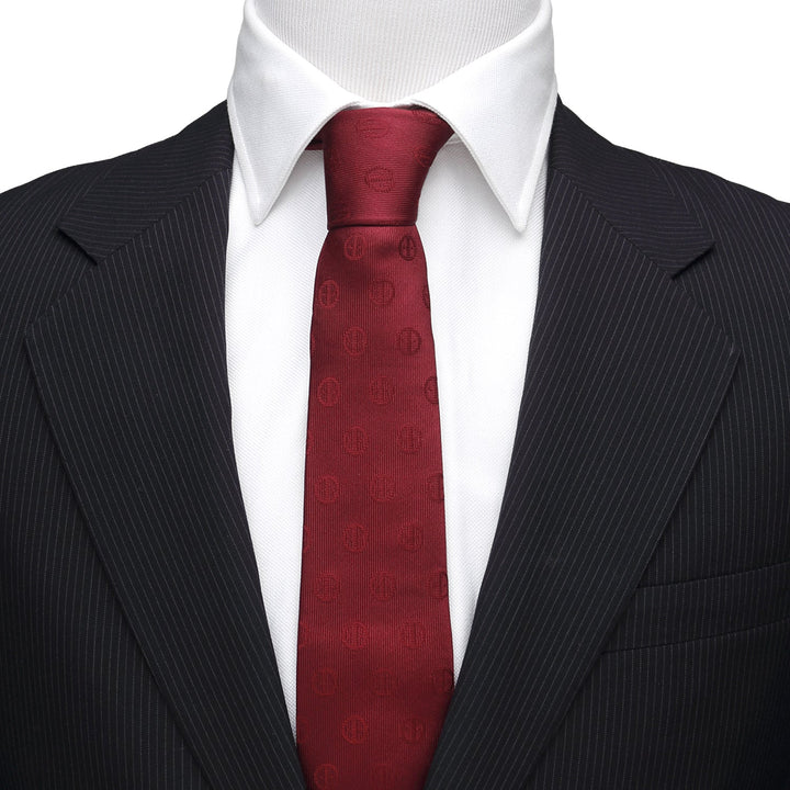 Marvel Deadpool Maroon Men’s Tie in a maroon repeating logo pattern, worn with a white shirt and black pinstripe suit jacket.