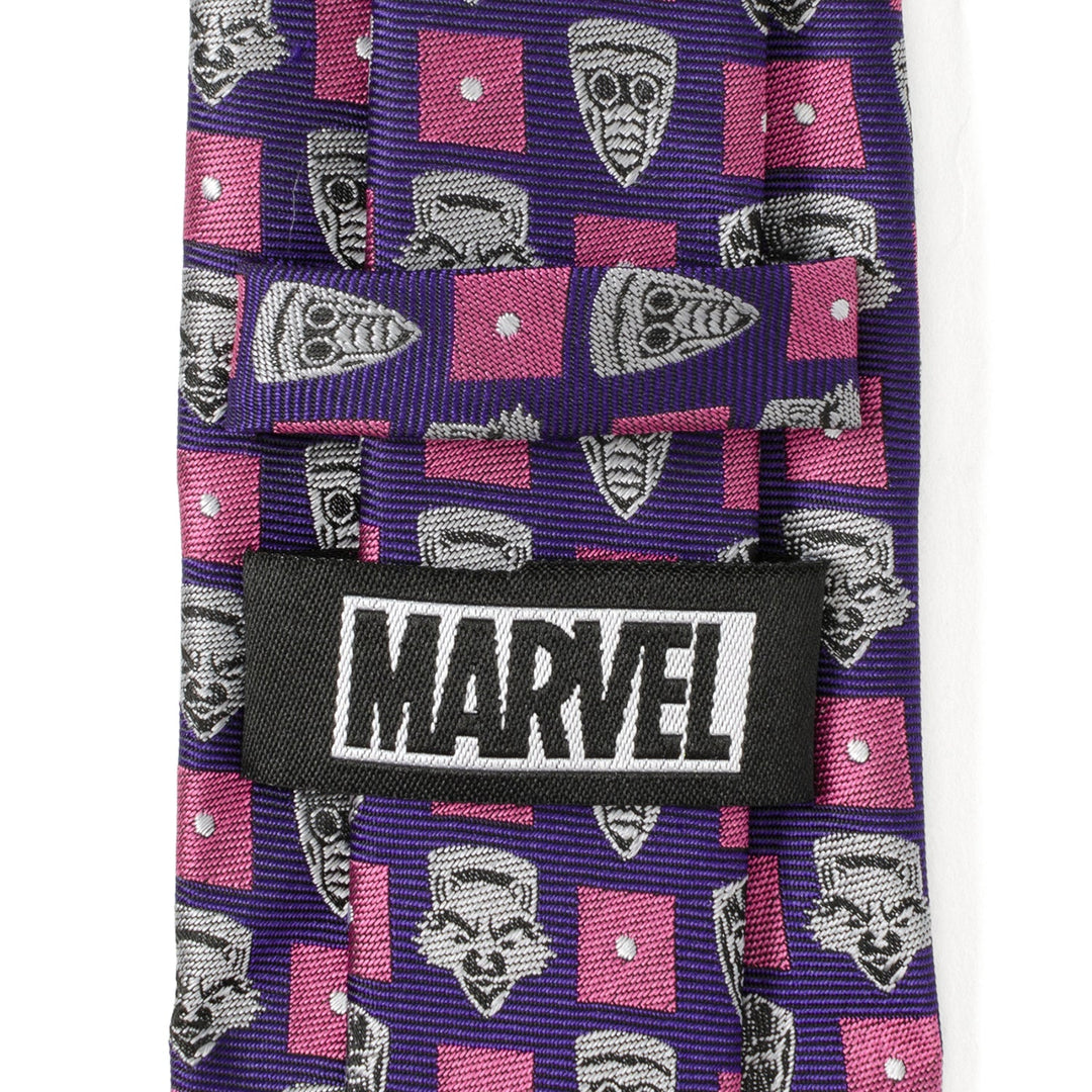 Marvel Guardian’s of the Galaxy Purple Men’s Tie featuring a repeating pattern of gray character faces and pink squares, with a black “MARVEL” label stitched on the back.