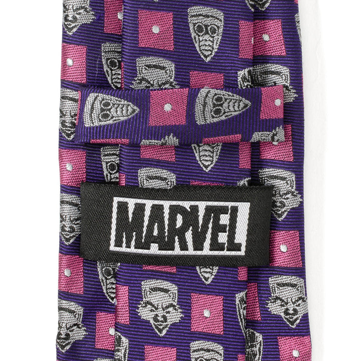 Marvel Guardian’s of the Galaxy Purple Men’s Tie featuring a repeating pattern of gray character faces and pink squares, with a black “MARVEL” label stitched on the back.