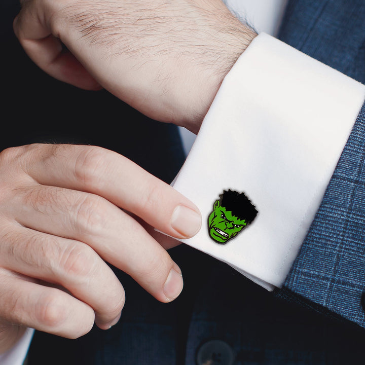 A person wearing a suit jacket and white dress shirt featuring a green Marvel Hulk Comics Pair Cufflinks on the sleeve.