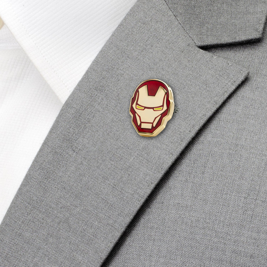 Red and gold enamel Marvel Iron Man Helmet Lapel Pin on a gray suit jacket.