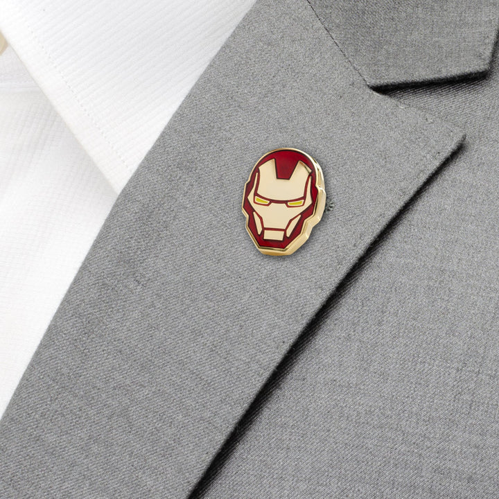Red and gold enamel Marvel Iron Man Helmet Lapel Pin on a gray suit jacket.