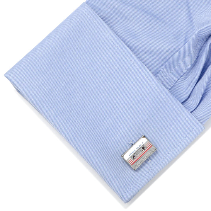 Marvel Guardians of the Galaxy Awesome Mix Tape No. 2 Cufflinks shaped like an “Awesome Mix Vol. 2” cassette tape attached to a light blue shirt cuff.