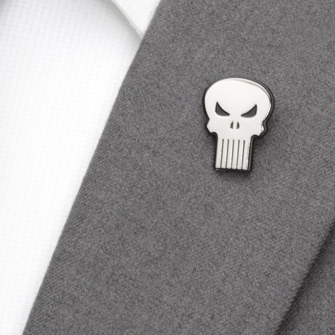 A silver Marvel The Punisher Silver Lapel Pin attached to a grey suit jacket lapel.