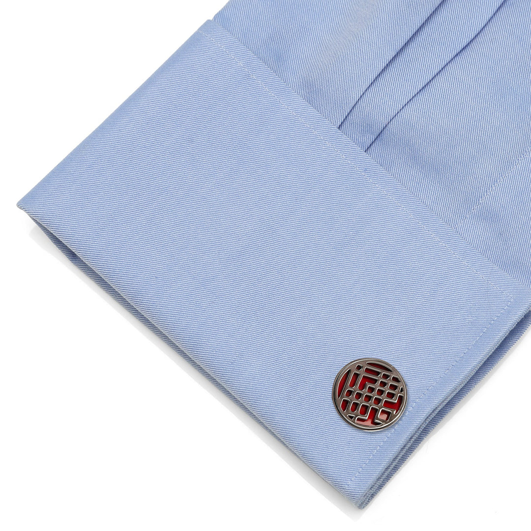 Round Marvel Shang-Chi Men’s Cufflinks with a red geometric pattern attached to a light blue dress shirt cuff.