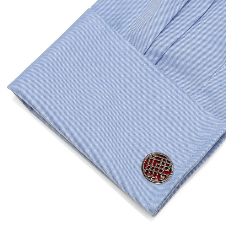 Round Marvel Shang-Chi Men’s Cufflinks with a red geometric pattern attached to a light blue dress shirt cuff.