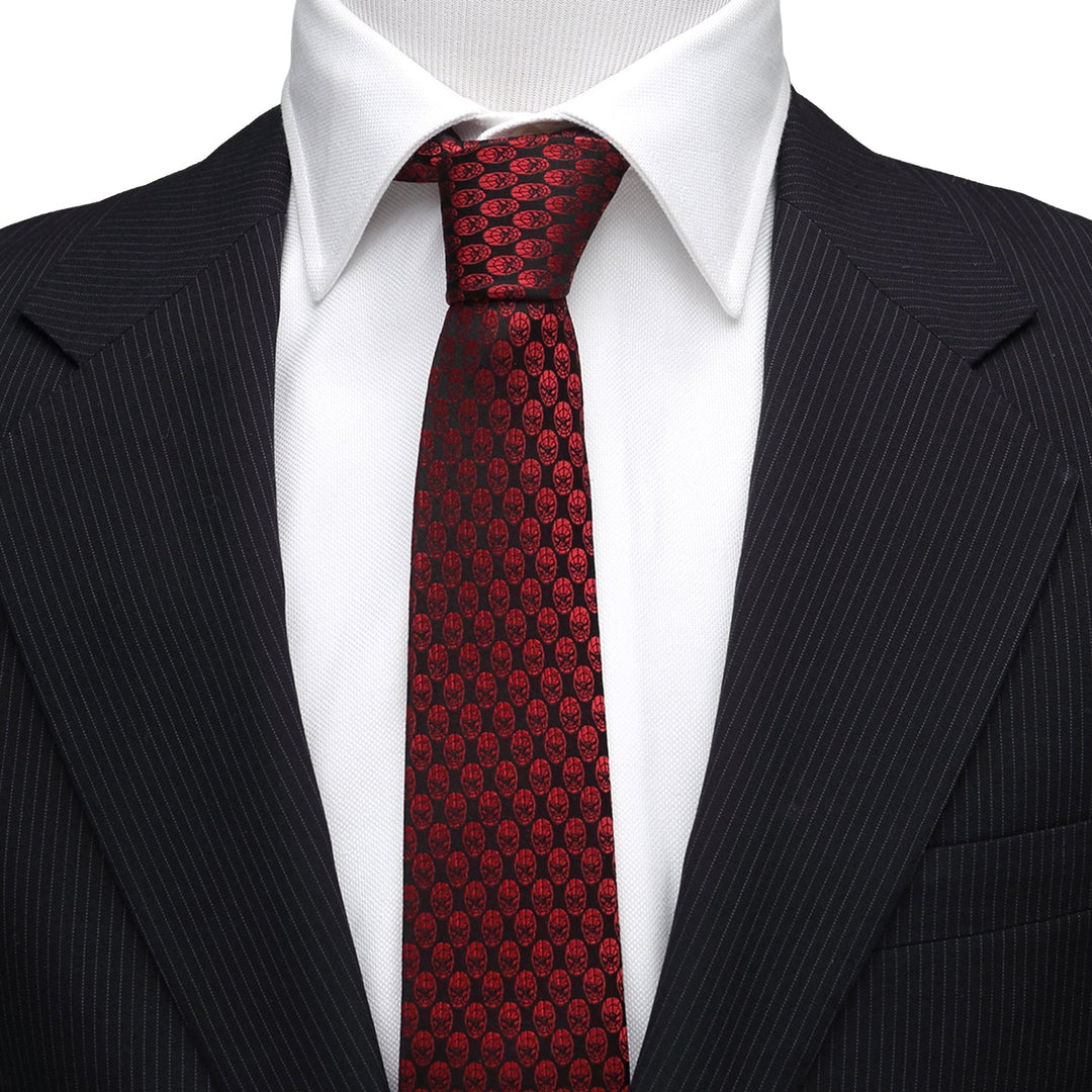 A Marvel Spider-Man Mask Red Men’s Tie in crimson with a repeating black spider-mask pattern, worn with a white dress shirt and dark pinstriped suit jacket.