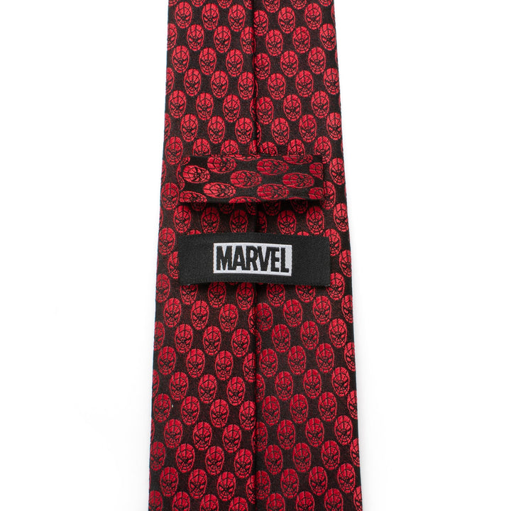 Marvel Spider-Man Mask Red Men’s Tie in crimson featuring a repeating pattern of black Spider-Man masks and a black label with the word “MARVEL” in white text.