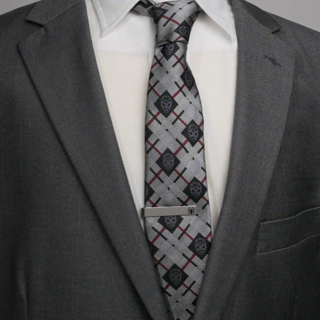 Silver Marvel Spider-Man Spider Tie Bar worn on a patterned tie with a grey suit and white dress shirt.