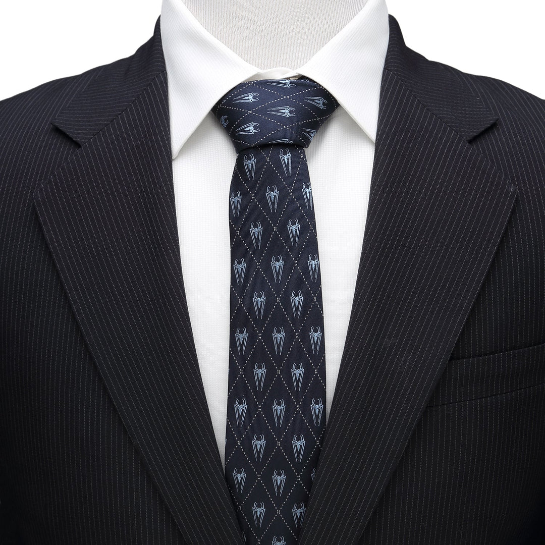 Marvel Spider-Man Diamond Navy Men’s Tie in navy blue silk with a white diamond grid pattern and small spider icons, worn with a white collared shirt and black pinstripe suit jacket.