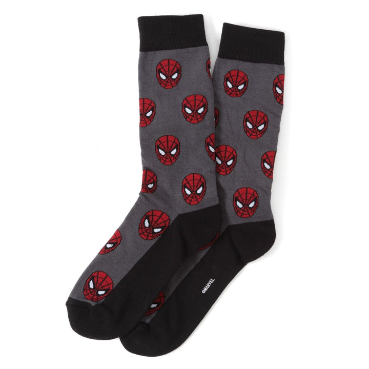 Two gray crew socks from the Marvel Spider-Man 3 Pack Socks and Lapel Pin Gift Set, featuring black cuffs and heels with a repeating red Spider-Man mask pattern.
