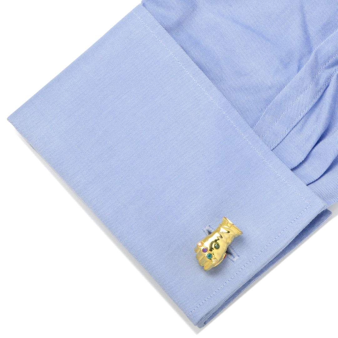 Marvel Thanos Infinity Gauntlet 3D Cufflinks featuring gold-colored metal with colorful inlaid stones, attached to a light blue dress shirt cuff.