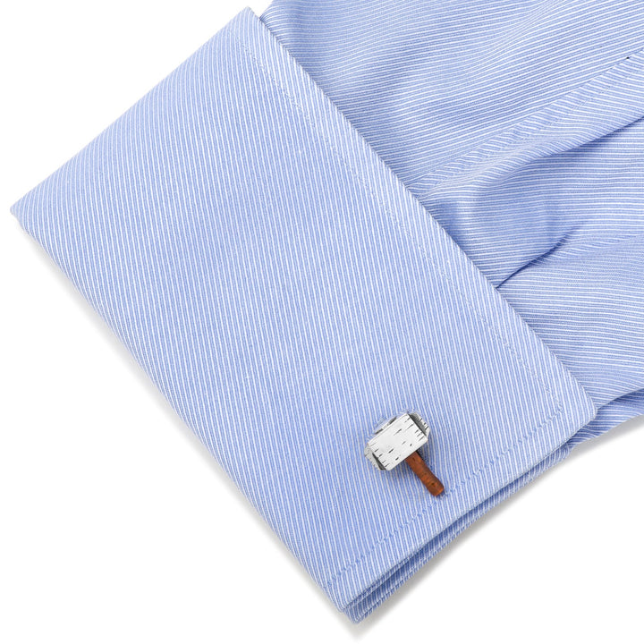 Marvel Thor Mjolnir 3D Cufflinks featuring a silver hammer with a brown handle attached to a light blue dress shirt cuff.