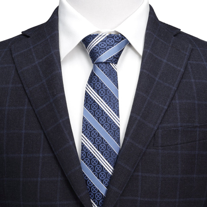 A Marvel X-Men Symbol Navy Stripe Men’s Tie in navy and light blue silk with a repeating circular pattern, worn with a white dress shirt and a dark plaid blazer.