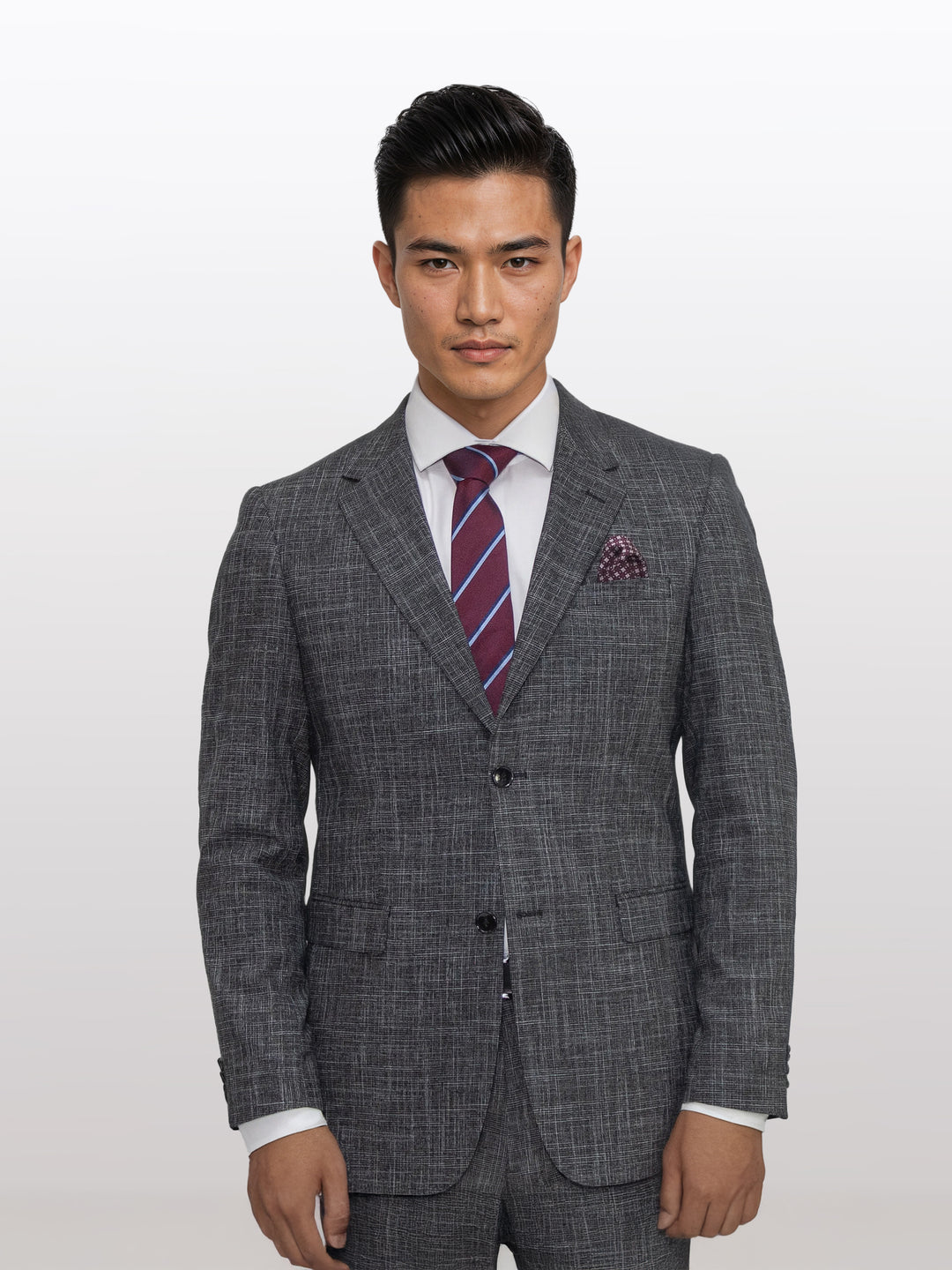 A man confidently stands against a plain background, dressed in Gianco Ferro&