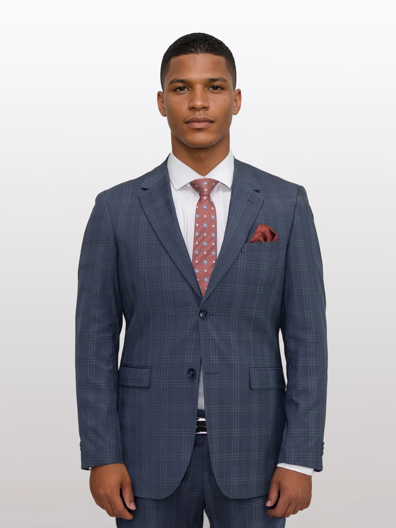 A person wearing a Gianco Ferro Men's Charcoal with Light Grey Tartan Slim Fit Suit, paired with a white shirt and pink patterned tie, stands against a plain background.