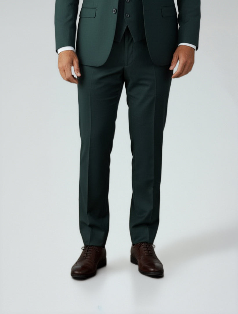A model is shown from the shoulders down wearing Men's Green Dress Pants by Couture 1910, paired with brown dress shoes, styled against a plain background.