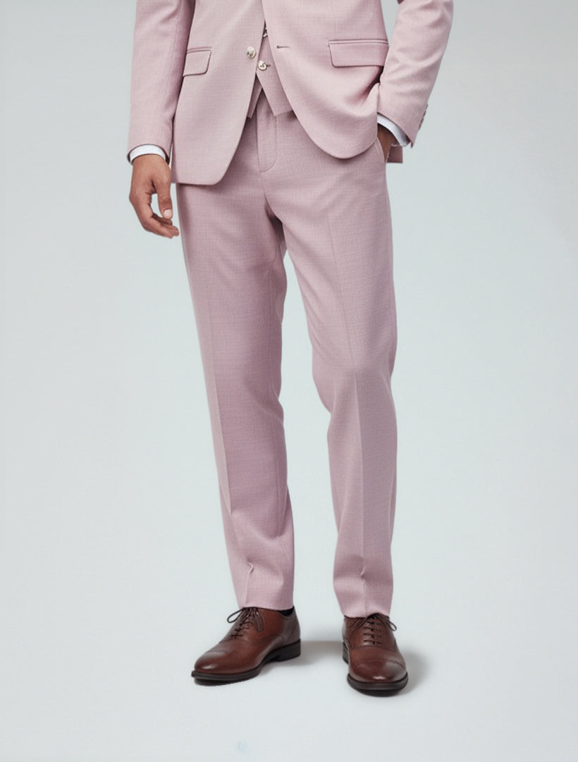 A man wears Couture 1910's Men's Rose Dress Pants, paired with a light pink suit, matching vest, white shirt, and brown shoes, standing against a plain light background.
