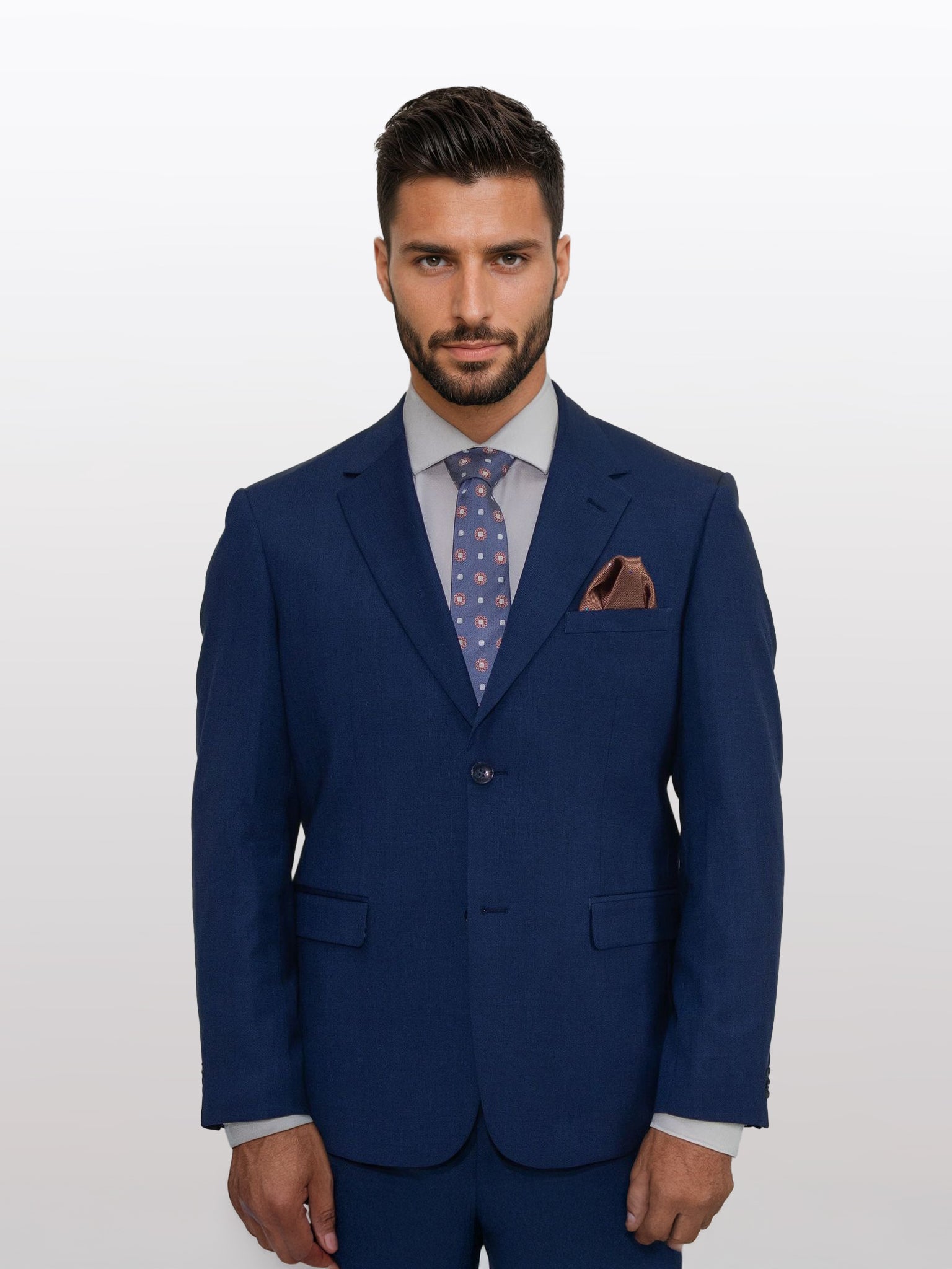 A man in a stylish Men's Royal Blue Micro Check Patterned Slim Fit Suit by Gianco Ferro stands against a plain background, with a patterned tie and a brown pocket square accentuating his attire.