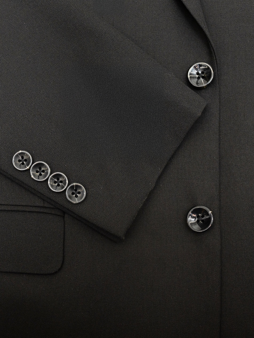 Close-up of the Mens Black Suit by Karako Men, featuring a jacket with four buttons on the sleeve and three on the front, ideal for any formal occasion.