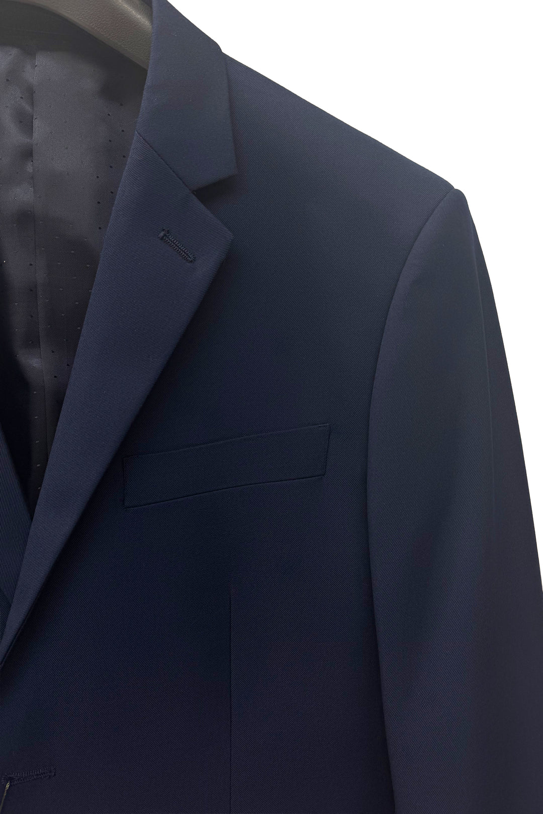 A close-up of the Karako Men Mens Navy Suit on a hanger features its lapel, chest pocket, and interior lining—ideal as a wedding suit for men.