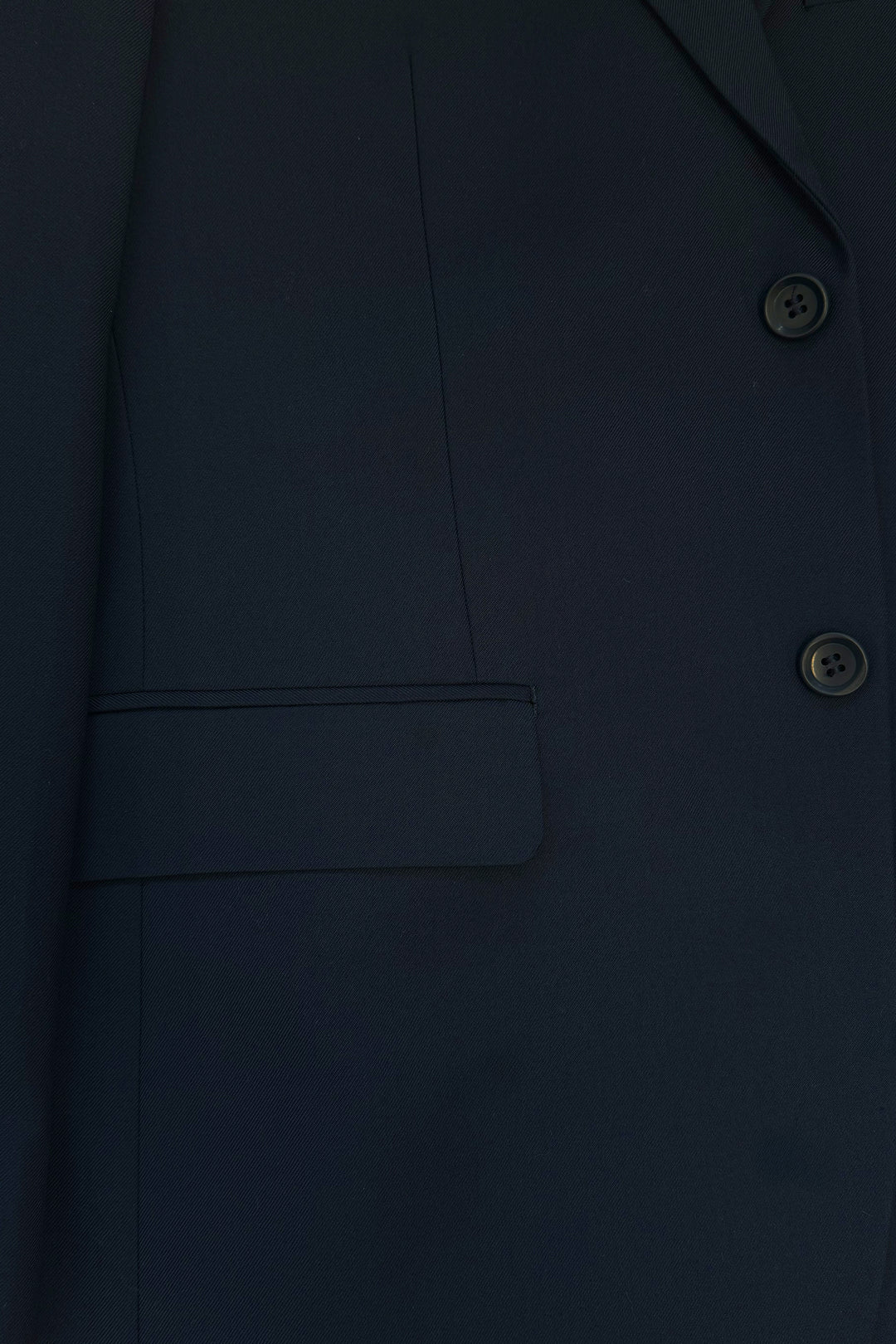 Close-up of the Karako Men Mens Navy Suit, featuring buttons, a lapel, and a side flap pocket—perfect as a men’s wedding suit.