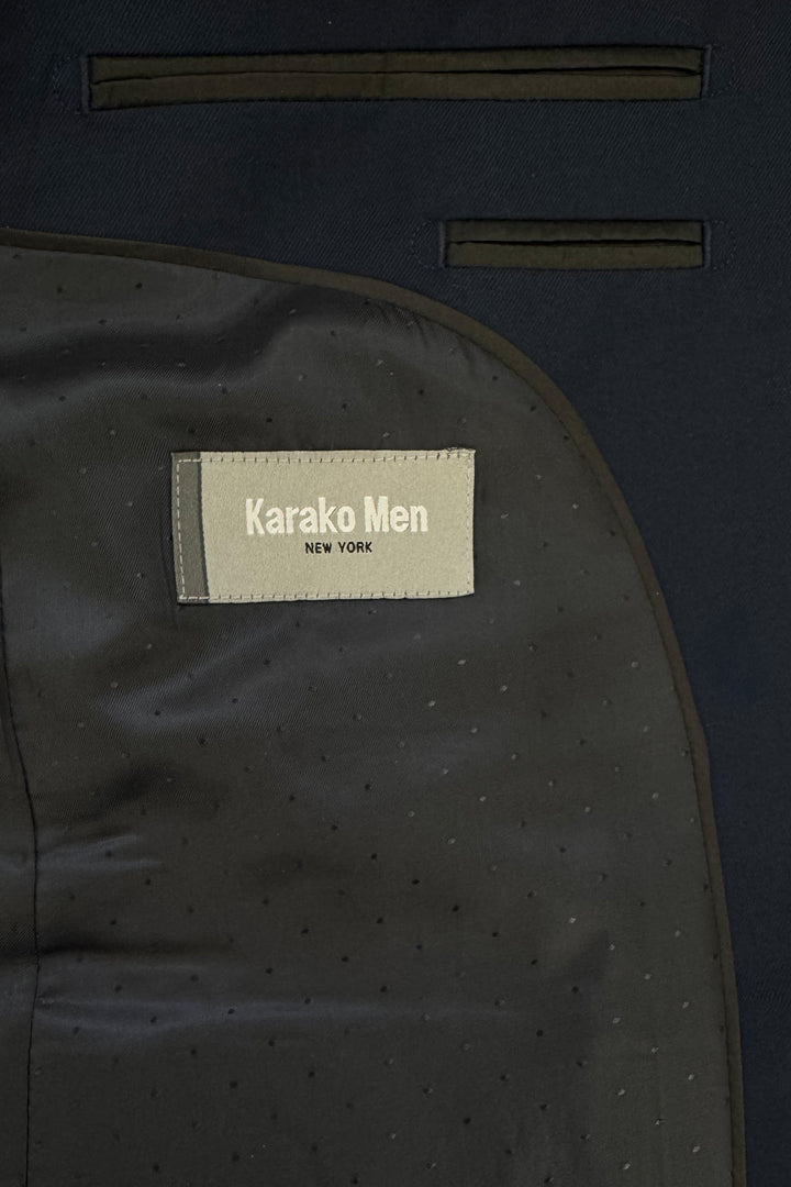 Close-up of the inside of a Mens Navy Suit by Karako Men, showing the label sewn onto the lining—ideal for anyone seeking a stylish suit for prom or weddings.