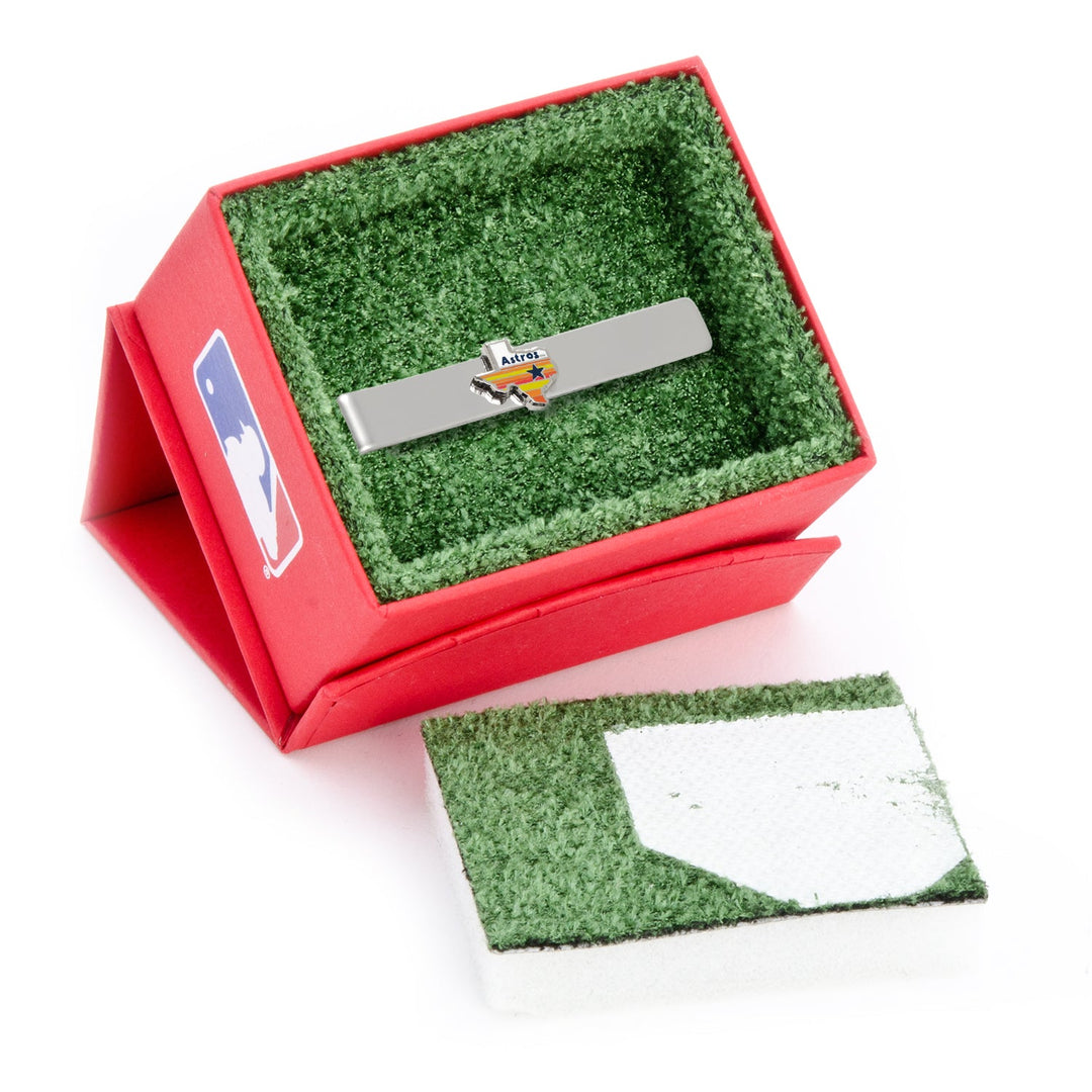 A silver MLB Houston Astros Tequila Sunrise Tie Bar featuring a Texas-shaped logo, presented in a box with a baseball field design.