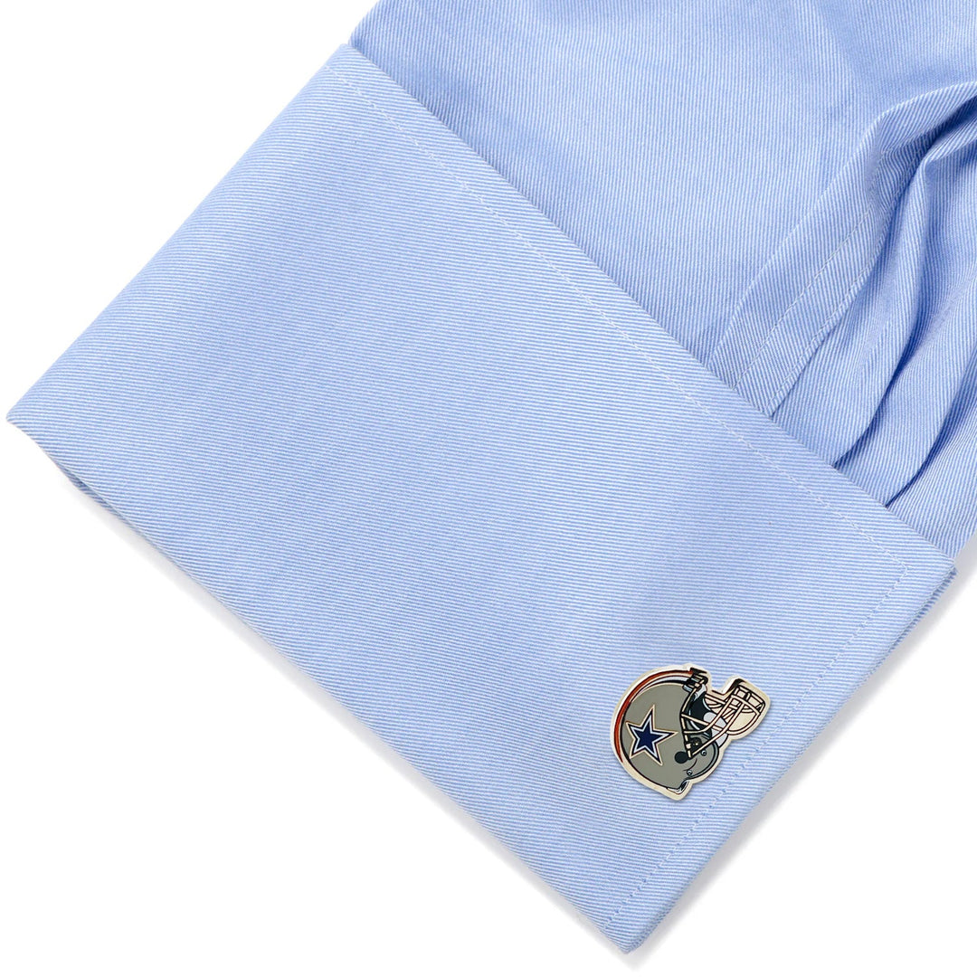 A blue dress shirt cuff fastened with NFL Dallas Cowboys Throwback Helmet cufflinks.