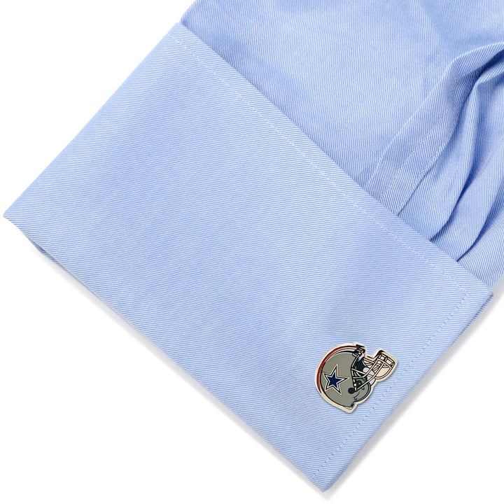 A blue dress shirt cuff fastened with NFL Dallas Cowboys Throwback Helmet cufflinks.