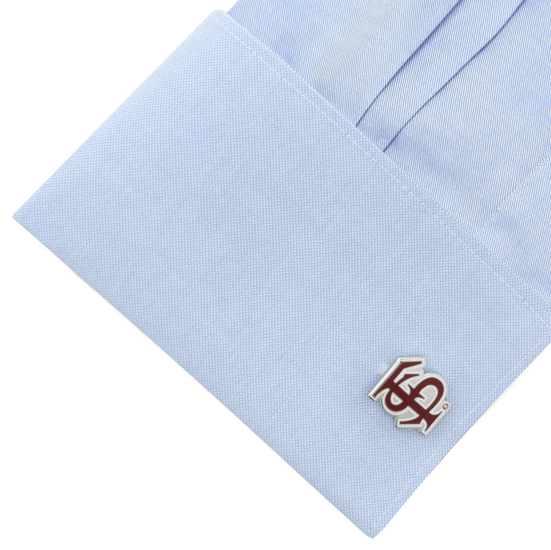 NCAA Florida State University Seminoles Cufflinks in silver-tone featuring an interlocking garnet and silver “FS” logo, attached to a light blue dress shirt cuff.