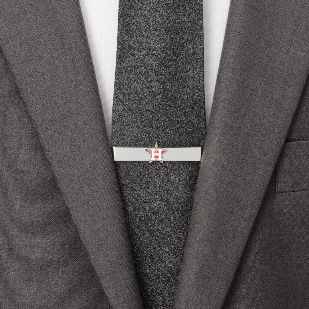 Silver-tone MLB Houston Astros Tie Bar clipped to a dark grey tie worn with a grey suit jacket.