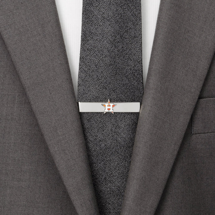 Silver-tone MLB Houston Astros Tie Bar clipped to a dark grey tie worn with a grey suit jacket.